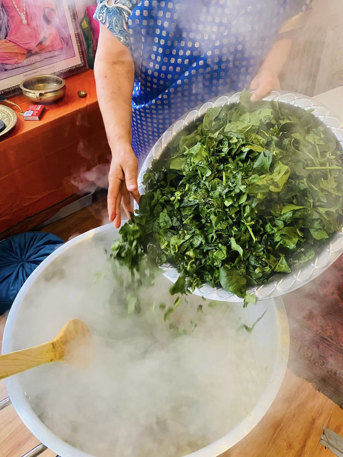 Volunteers preparing fresh greens for KAILASA Annalaya