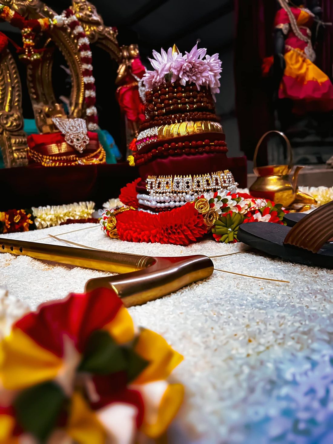 Sacred paduka worship with rudraksha, flowers and offerings