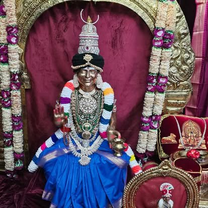Deity adorned in blue silk