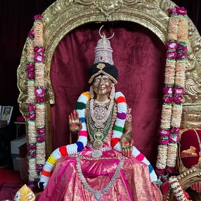 Deity adorned in pink silk