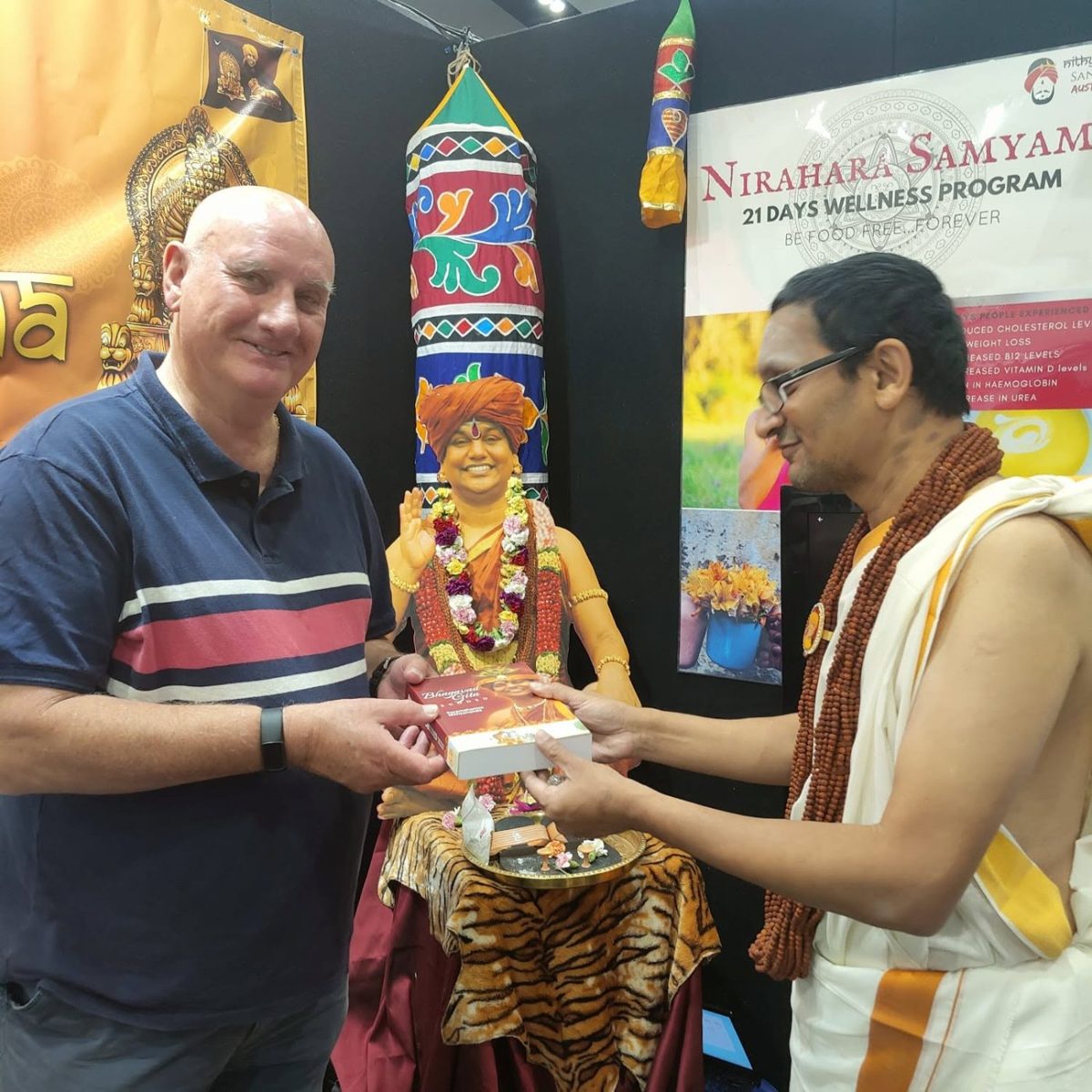 A devotee welcoming a visitor at the festival